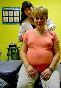 Dr. Haber-DiBoni examining a pregnant woman